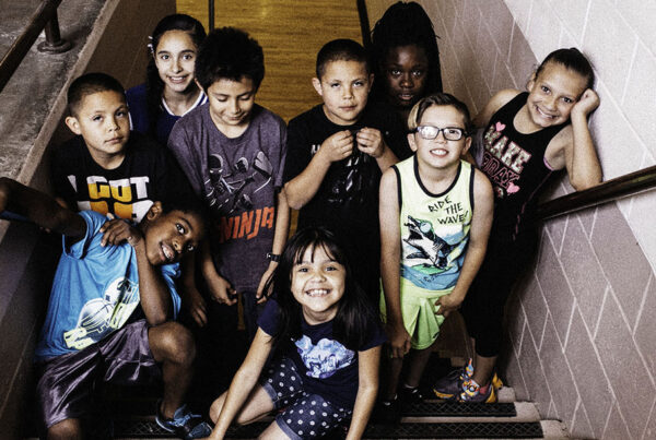 group of kids smiling on stairs